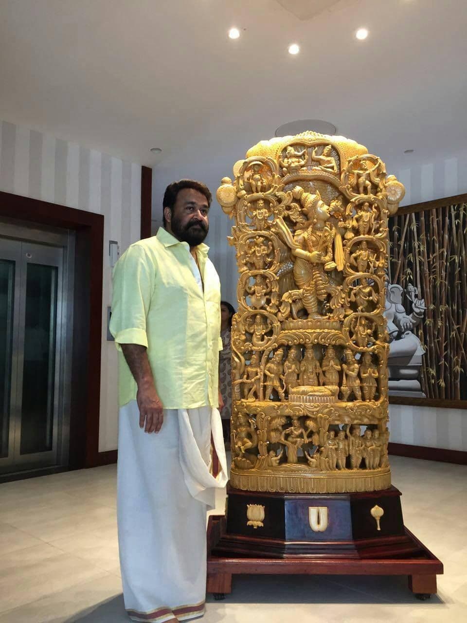Sri Mohanlal standing beside the intricately chiseled Dasavataram idol